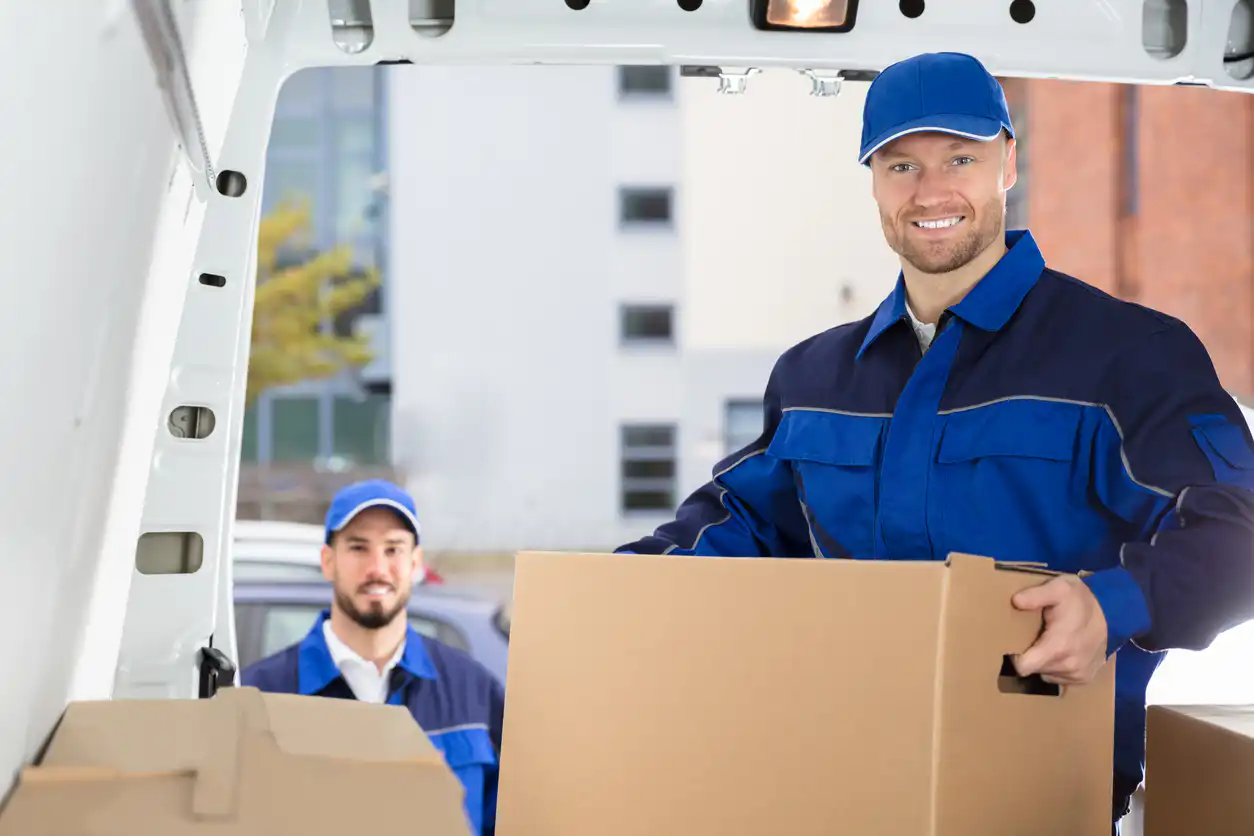 Mover Unloading Cardboard Box From Truck